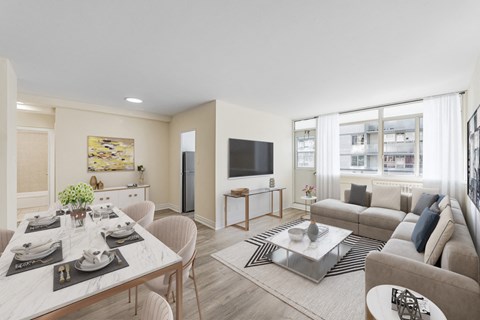 A modern living room with a dining table set for two.