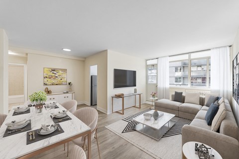 A modern living room with a dining table set for two.