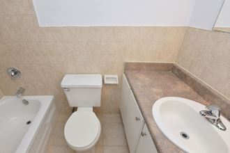 a bathroom with a toilet and a sink and a bath tub