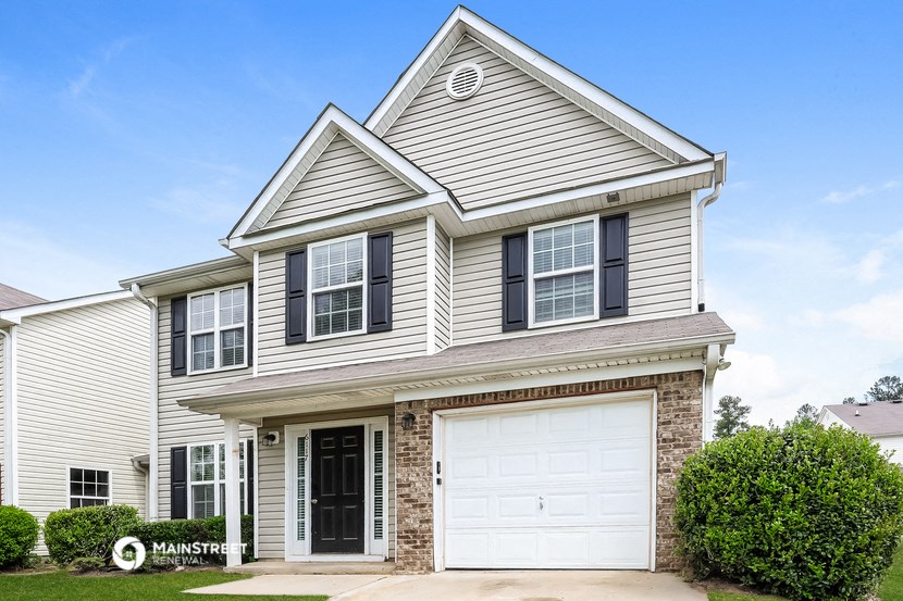 a white house with a white garage door
