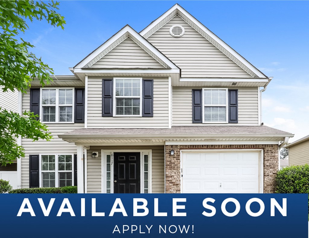 a beige house with a sign that reads available soon