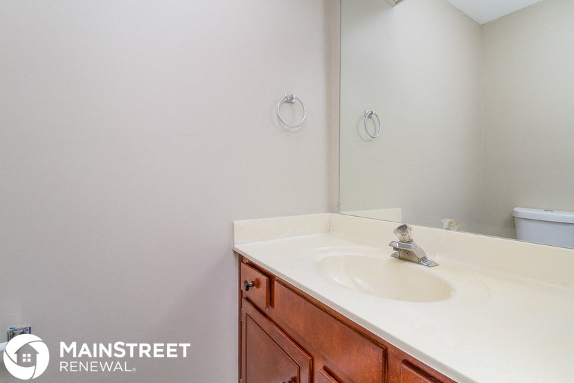a bathroom with a sink and a mirror and a toilet