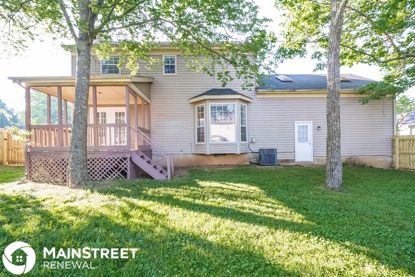 a white house with a yard and a porch
