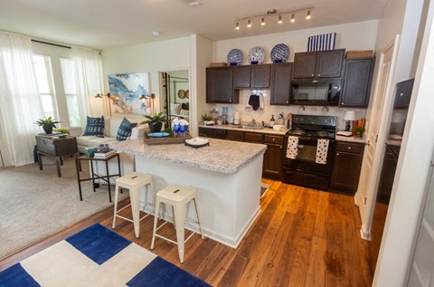 a kitchen and living room with a counter top