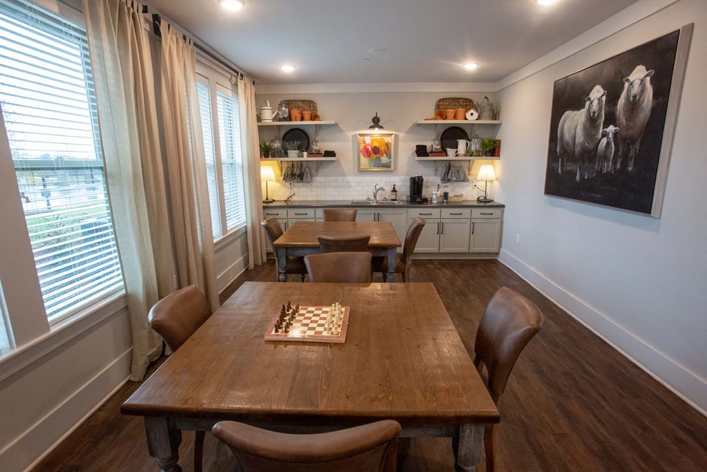 a dining room with a table and chairs and a chess board