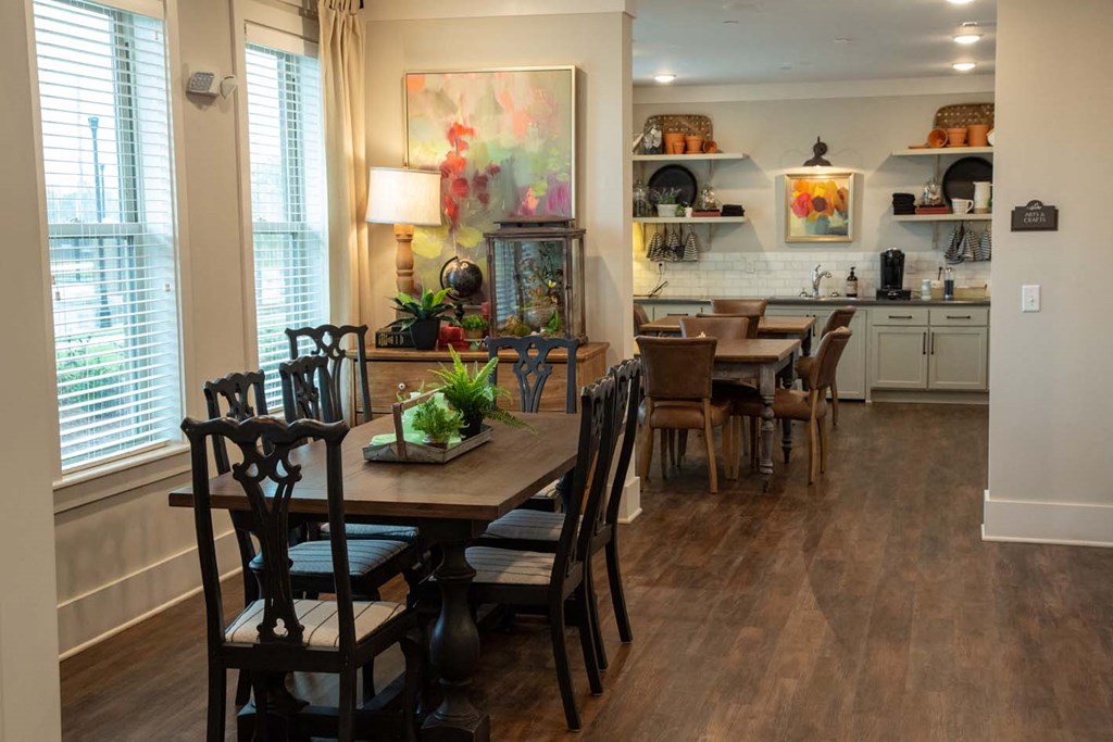 a dining room and kitchen with a table and chairs