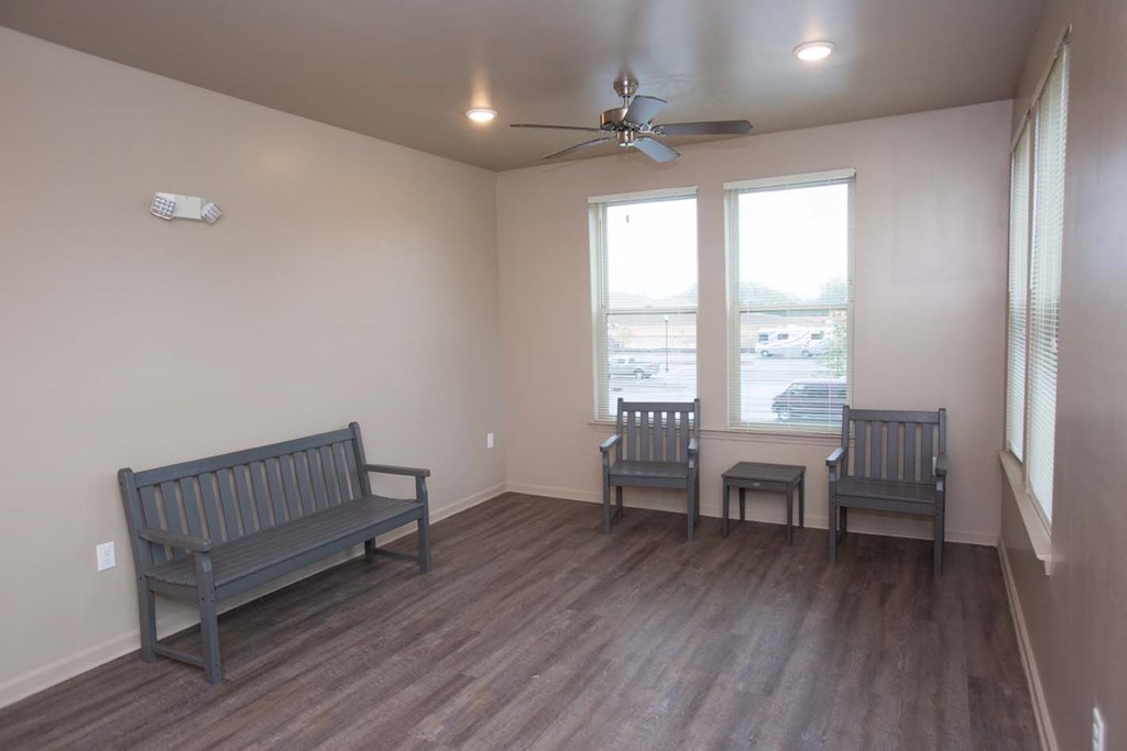 a living room with two benches and a ceiling fan