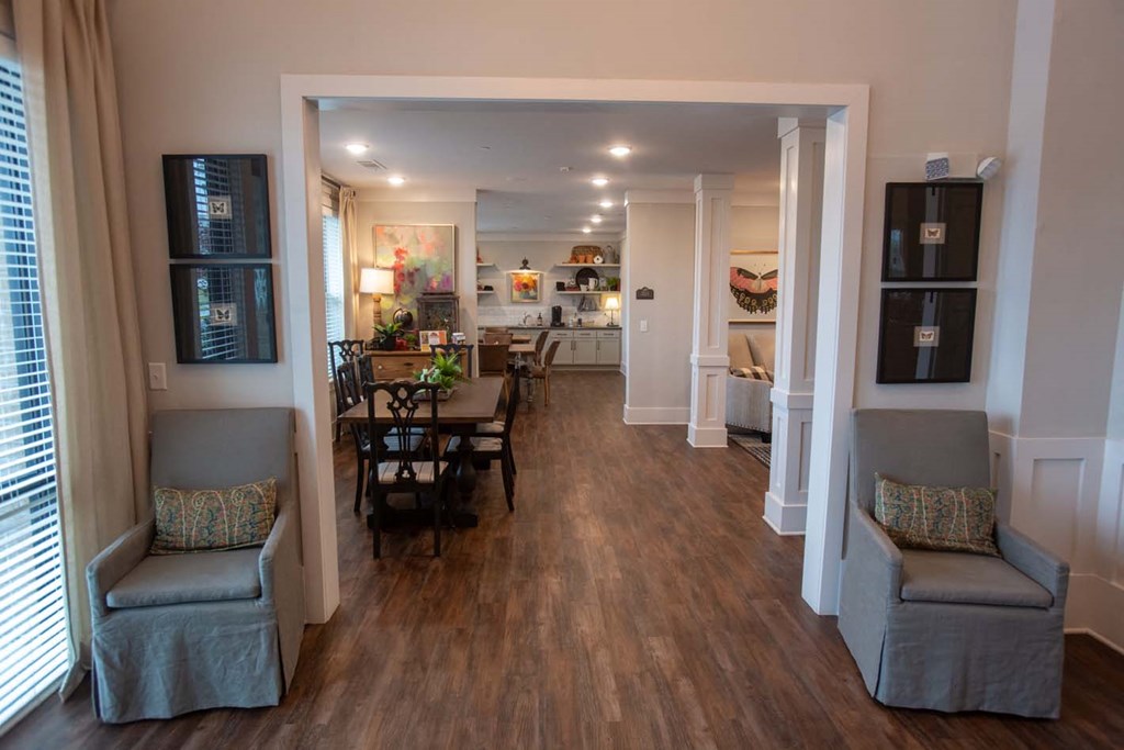 a living room and dining room with a hard wood floor