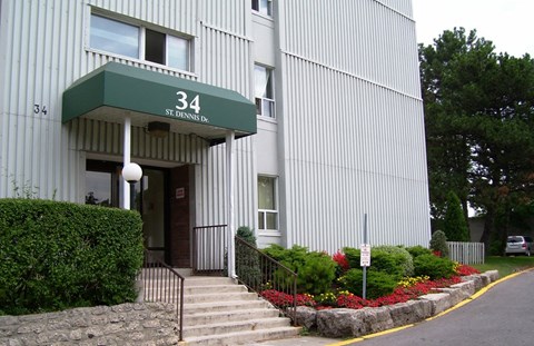 A building with a green awning and the number 34 on it.