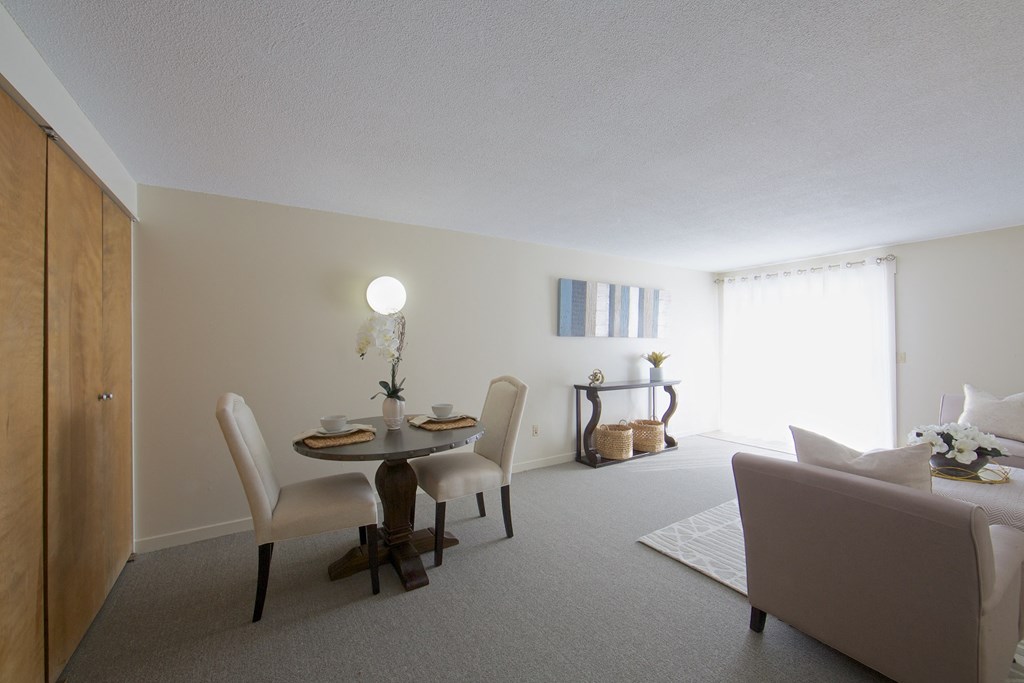 a living room with a table and chairs and a couch