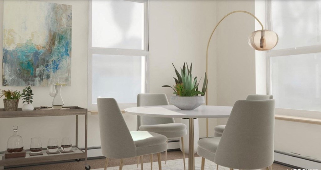 a dining room with a table and chairs and a lamp