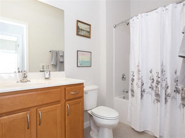 a bathroom with a toilet and a shower and a sink