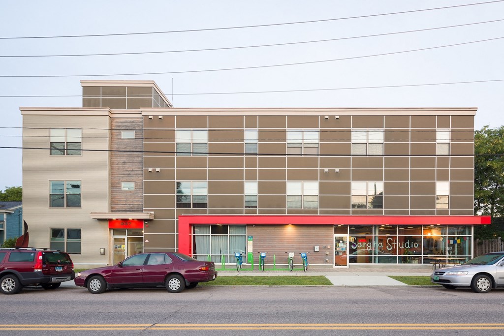 a large building with cars parked in front of it