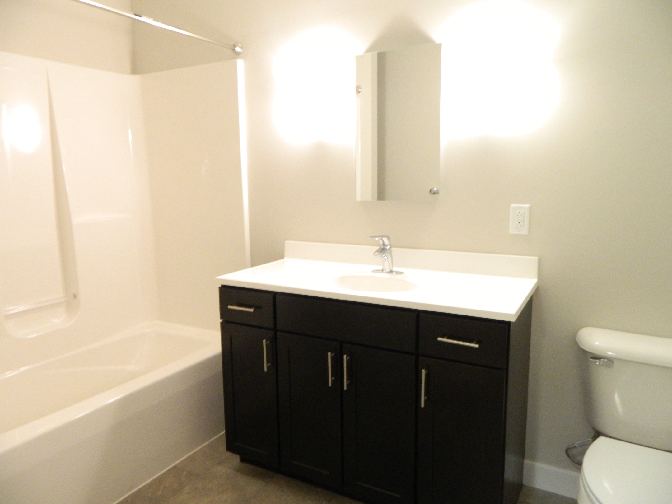 a small bathroom with a sink toilet and bath tub