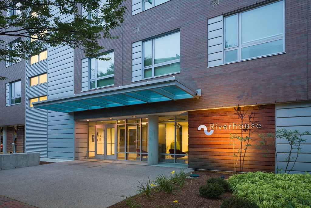 an entrance to a building with a door and a sign on the side of it