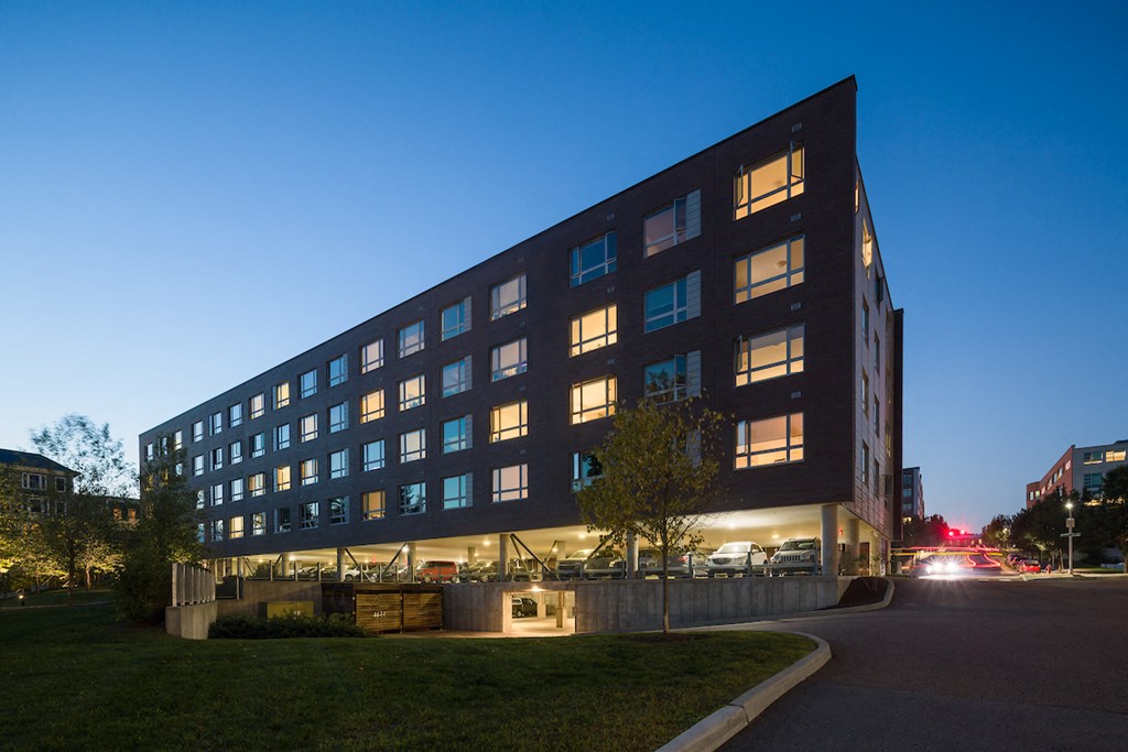 a large building at night with lights on in the windows