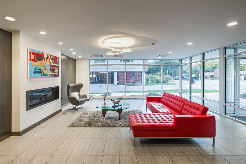a living room with red couches and a coffee table
