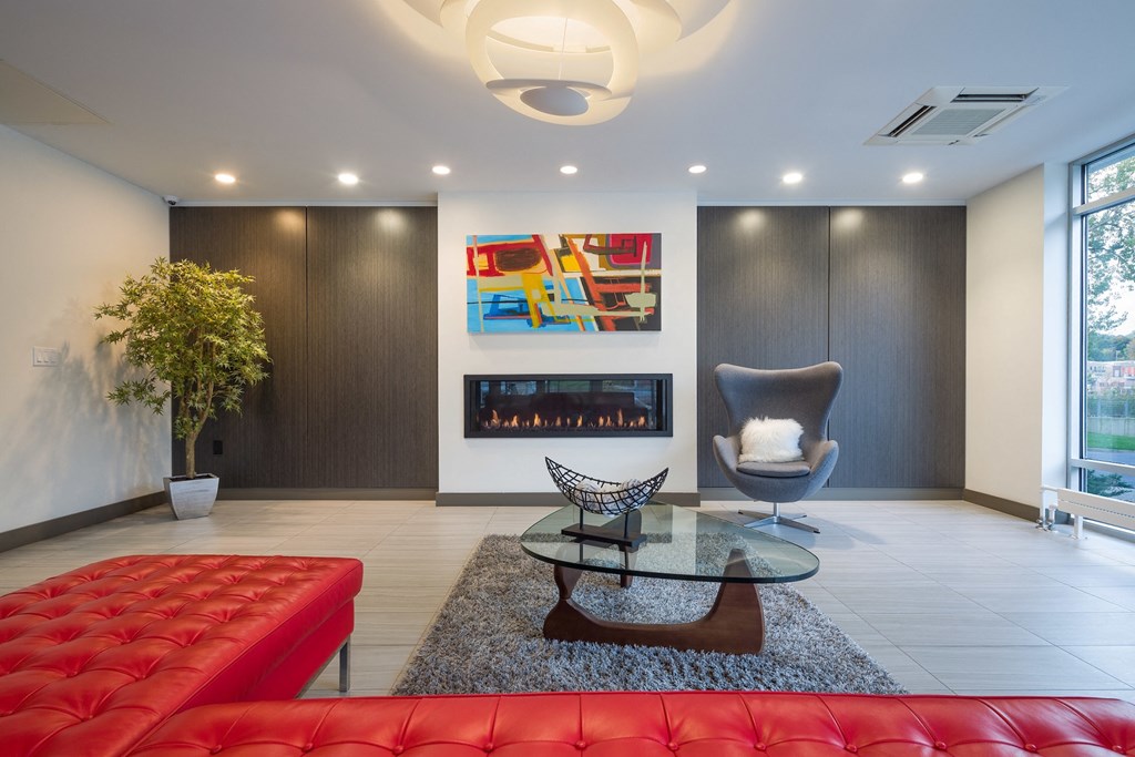 a living room with a red couch and a glass table