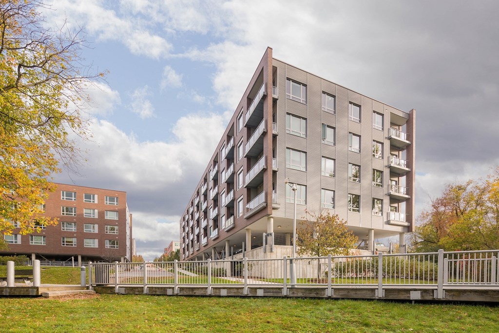 a large apartment building with a fence in front of it