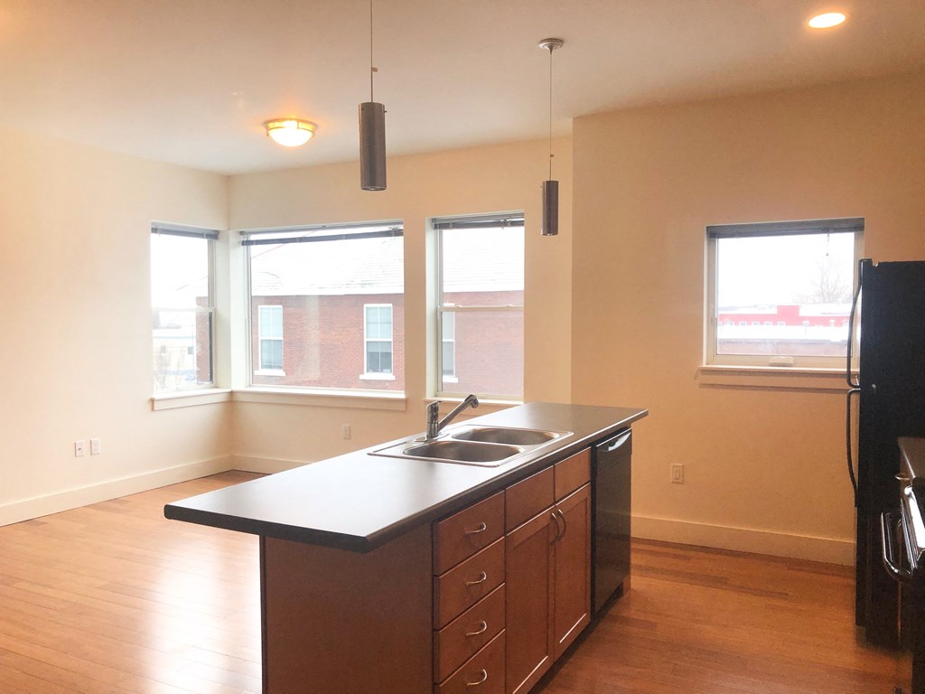 an empty kitchen with a sink and a window