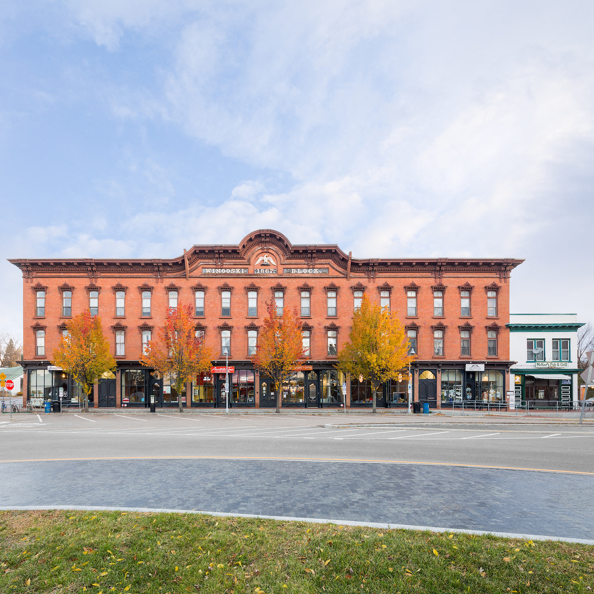a large brick building on the corner of a city street