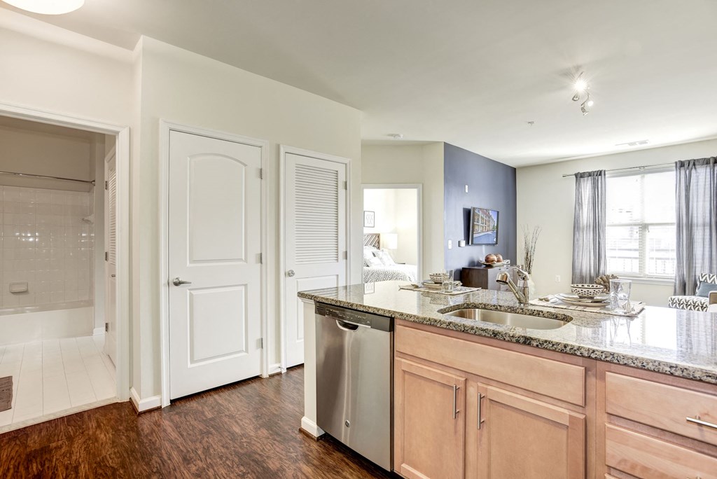 a kitchen with a sink and a door to a bathroom