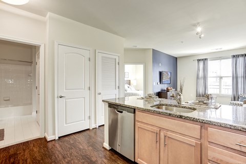 a kitchen with a sink and a door to a bathroom