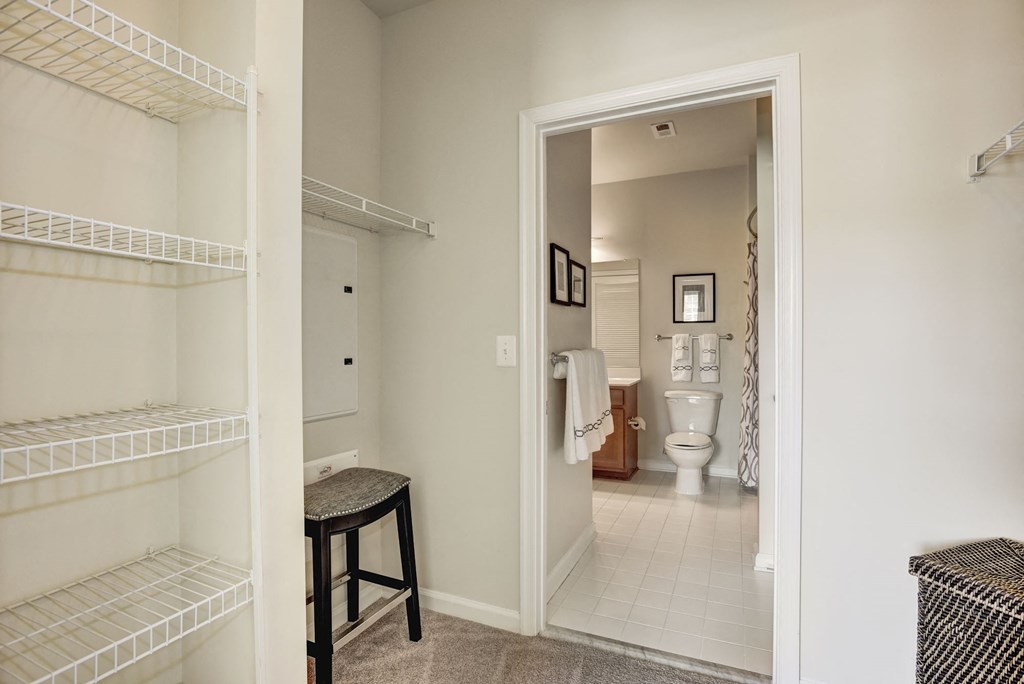 a bedroom with a closet and a bathroom with a toilet