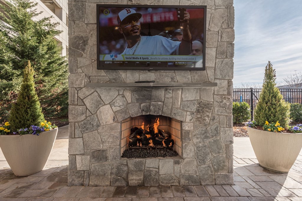 a stone fireplace with a tv on top of it