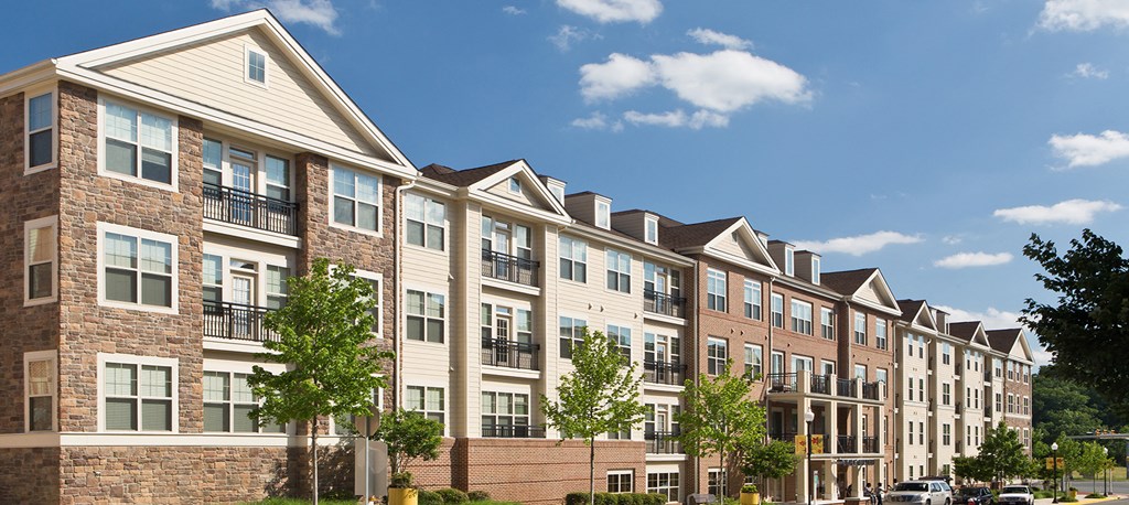 a large apartment building with brick and wood exterior