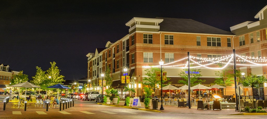 a city street at night with street lights and buildings