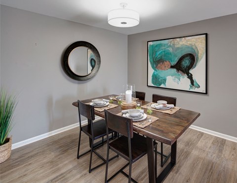 wood table and wall art in a dining nook