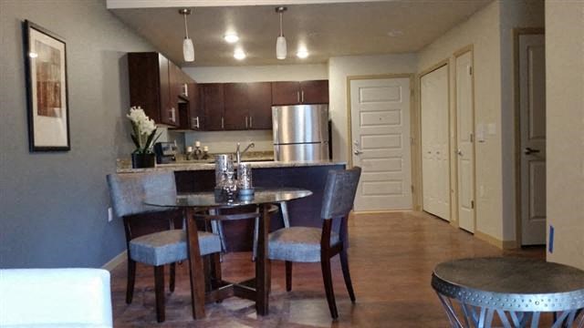 a kitchen and dining area with a table and chairs