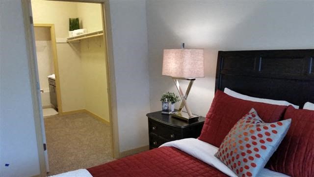 a bedroom with a bed and a lamp