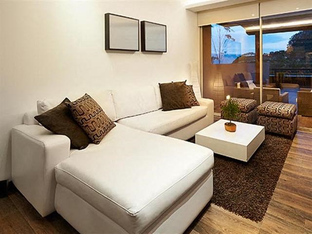 a living room with a white couch and a table