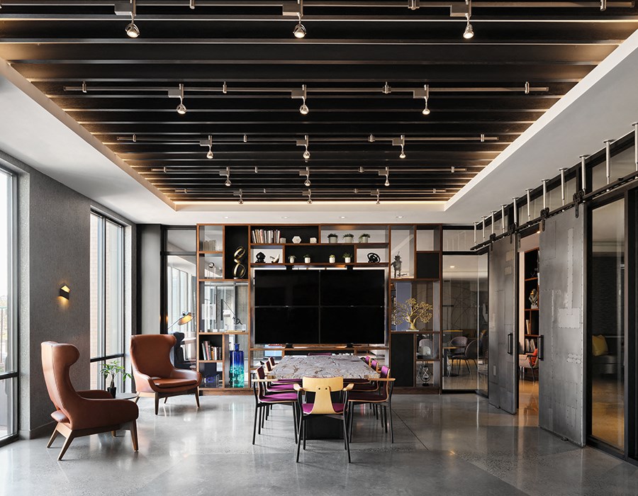 a living room with a table and chairs and a large television