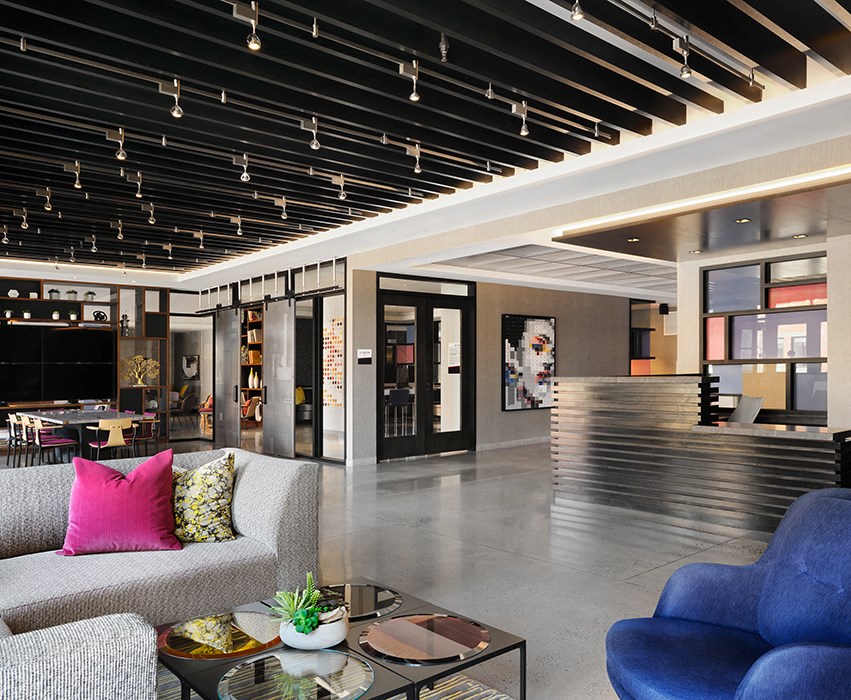 a lobby of a hotel with couches and a coffee table