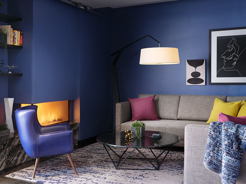 a living room with blue walls and a couch and a table