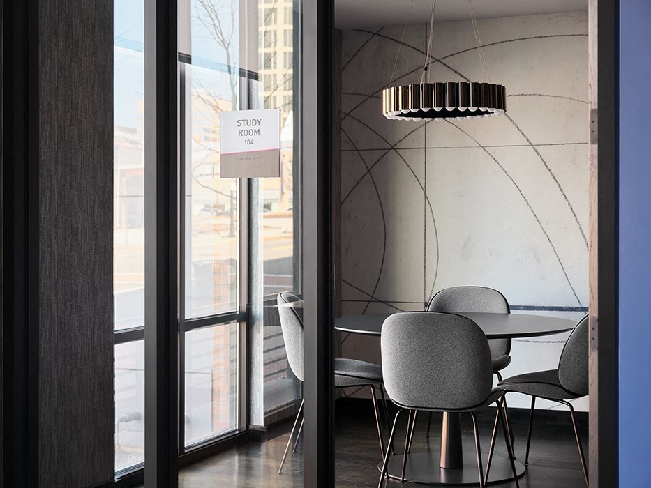 a dining room with a table and chairs and a large window