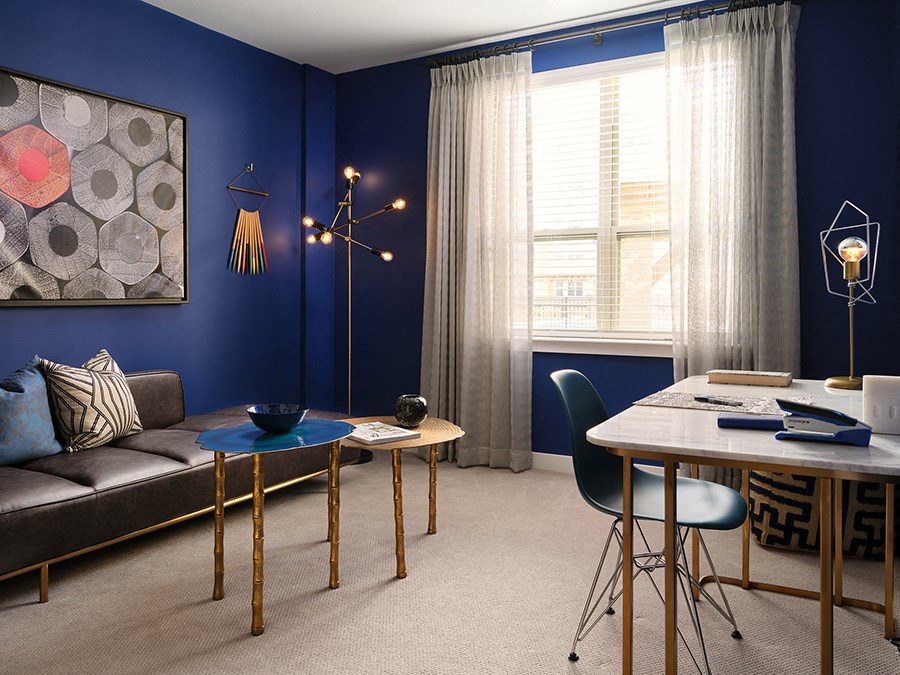 a living room and dining room with blue walls and a table and chairs