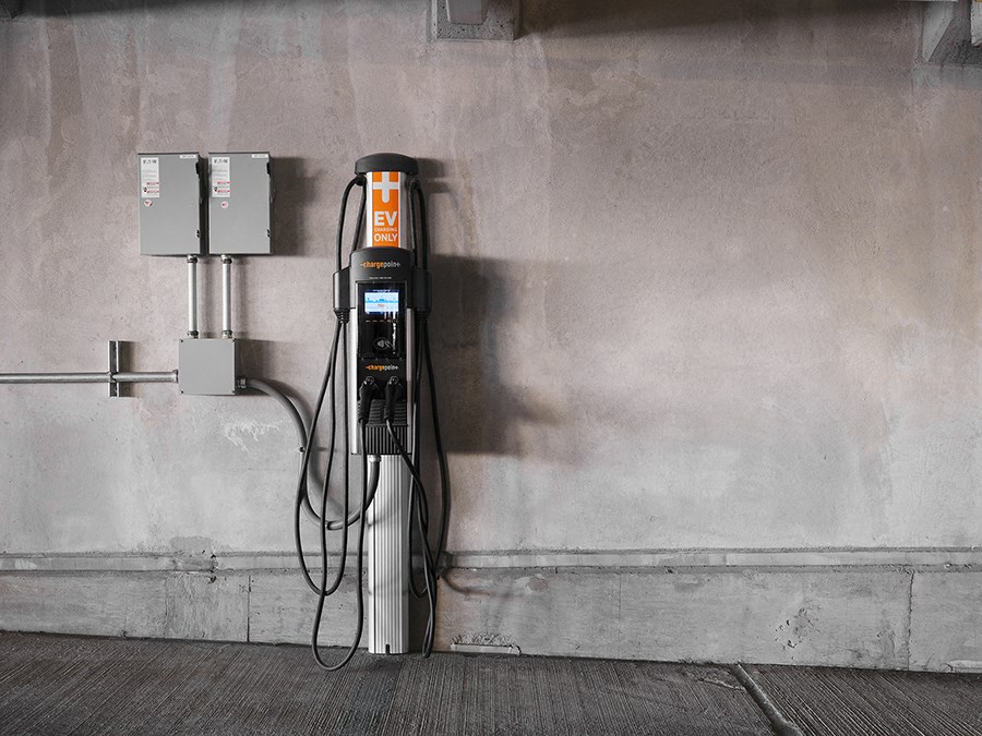 a gas pump plugged into the wall of a building