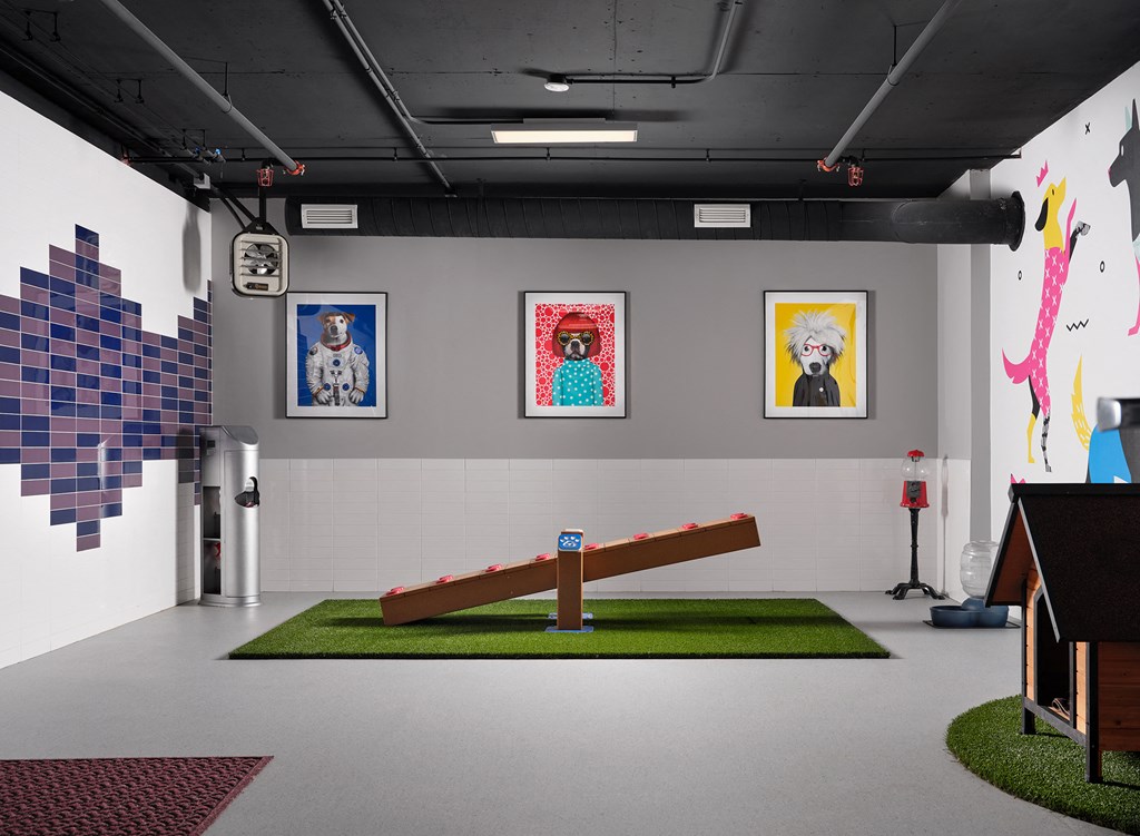 a large room with a crucifix in the middle of it and paintings on the wall