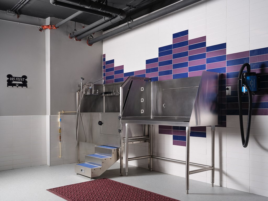 a large stainless steel kitchen in a room with stairs