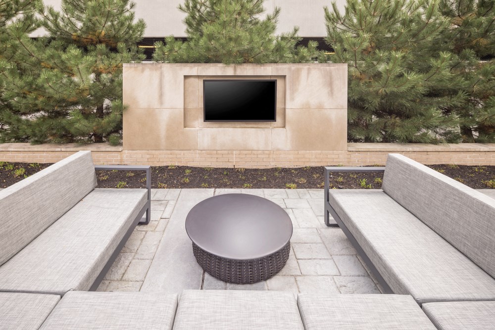 a seating area with two couches and a fire pit