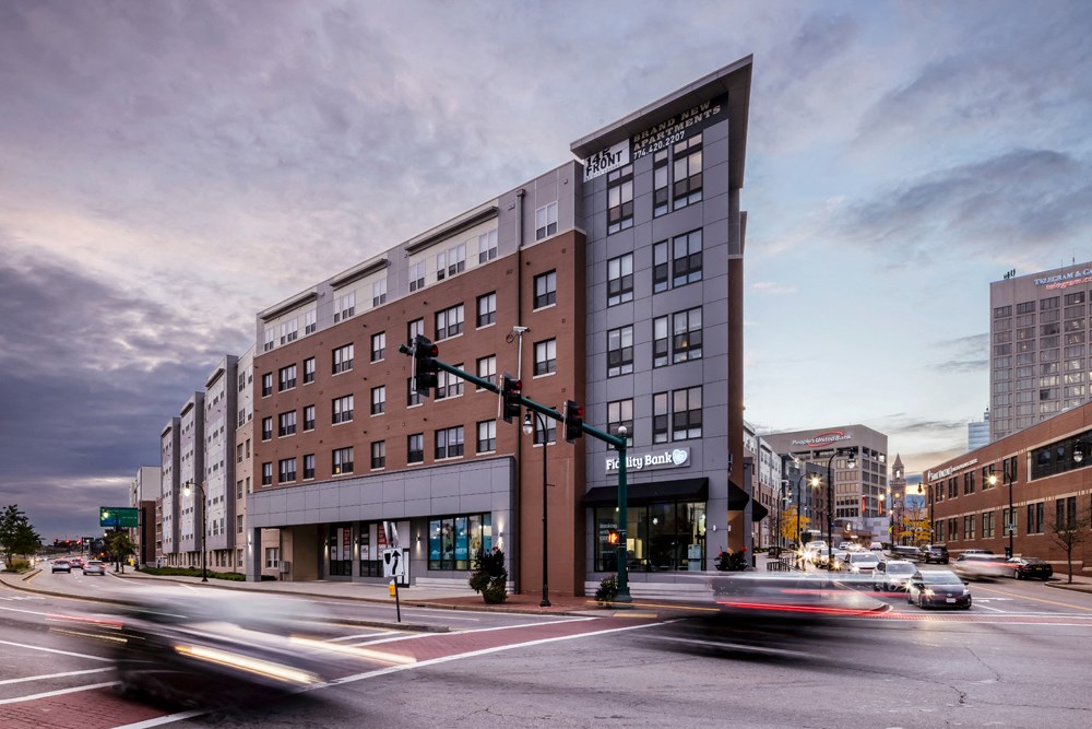 a large building on the corner of a busy city street