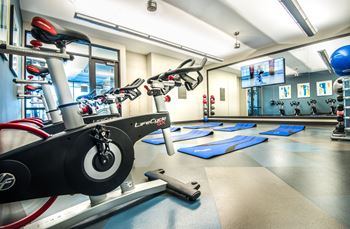 Yoga room and spin studio featuring Fitness On Demand™