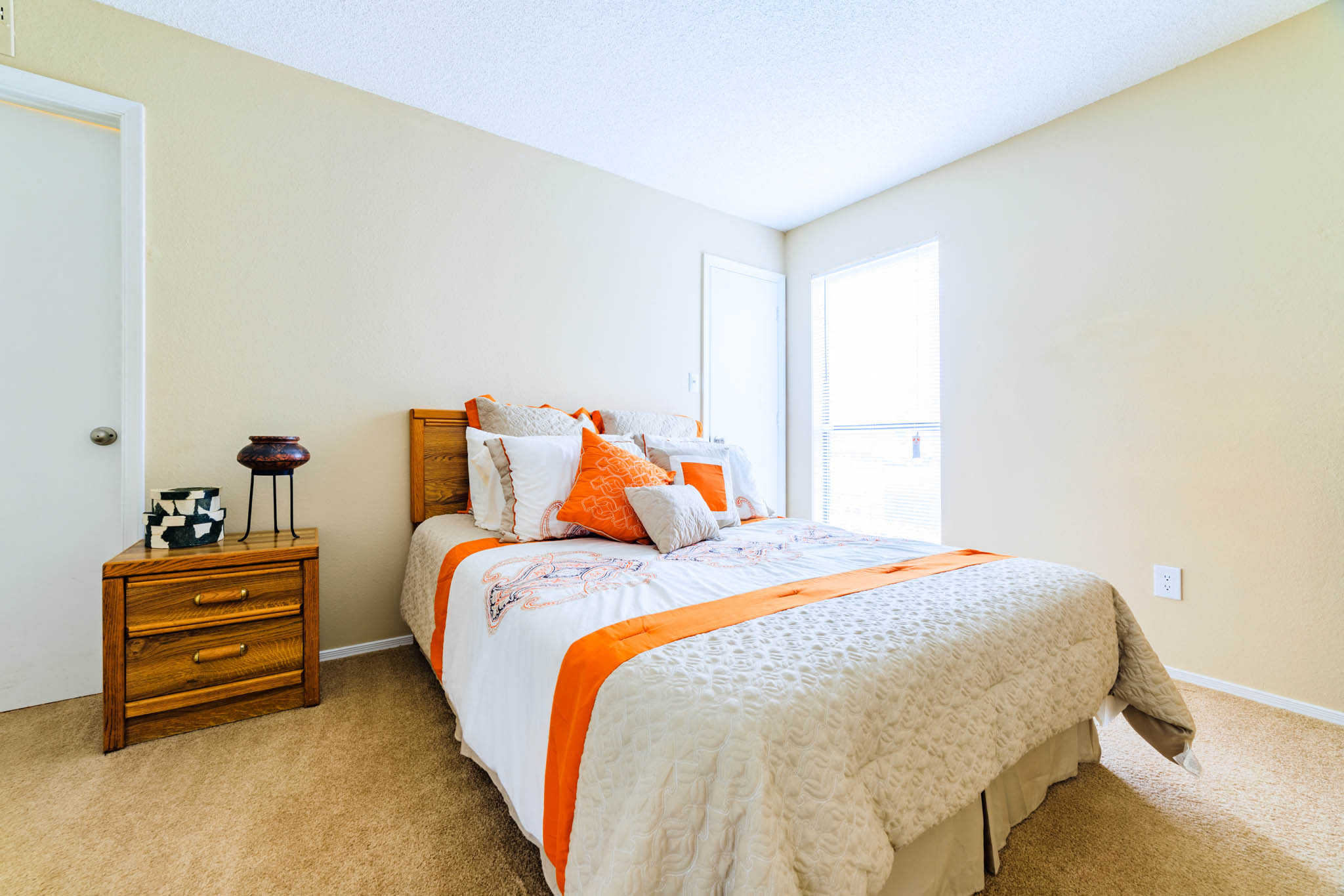 Forest Lake at Oyster Point in Newport News, VA interior view of bedroom two with orange and white linens
