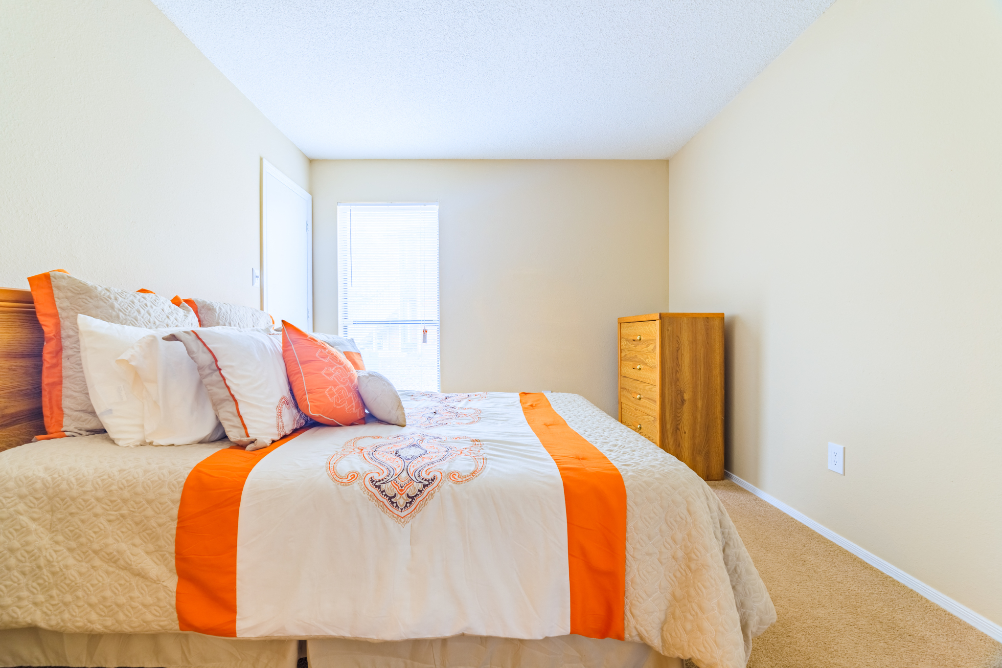 Forest Lake at Oyster Point in Newport News VA interior view of bedroom with orange and white linens