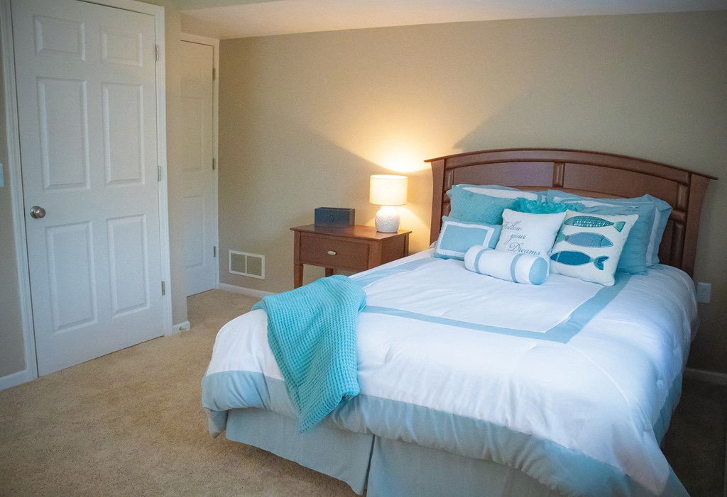 a bedroom with a large bed and a closet