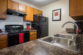 kitchen with black appliances and granite counter tops and a stainless steel sink